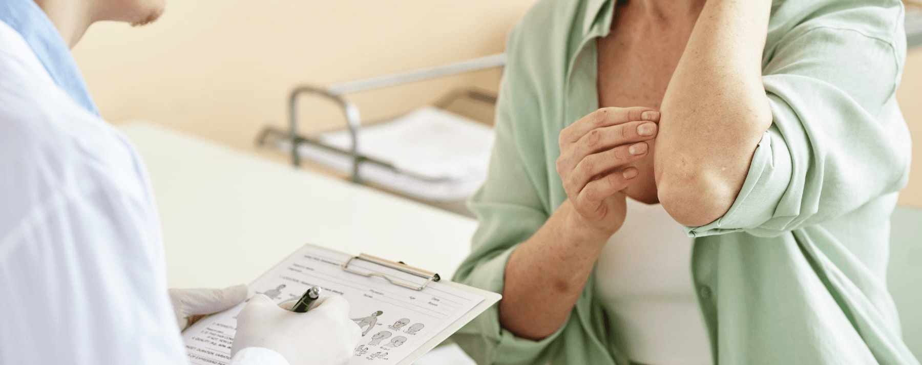 Close up of a person showing her elbow skin to a healthcare professional